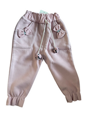 Pink fleece-lined toddler girl jogger pants with bows, pockets, and pom-pom drawstring ties