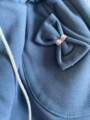 Blue pocket fleece-lined toddler girl jogger pants with bows, pockets, and pom-pom drawstring ties
