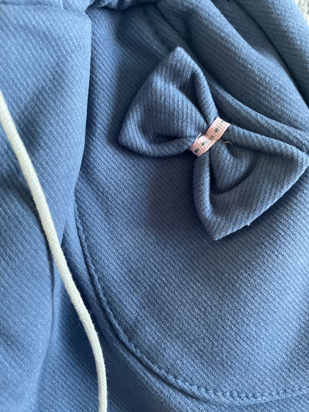 Blue pocket fleece-lined toddler girl jogger pants with bows, pockets, and pom-pom drawstring ties