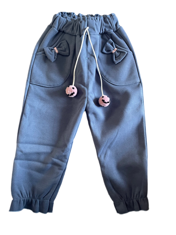 Blue fleece-lined toddler girl jogger pants with bows, pockets, and pom-pom drawstring ties