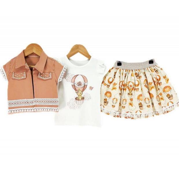 Toddler girl 3-piece outfit with hot air balloon print shirt, terracotta lace jacket, and matching printed skirt on hangers